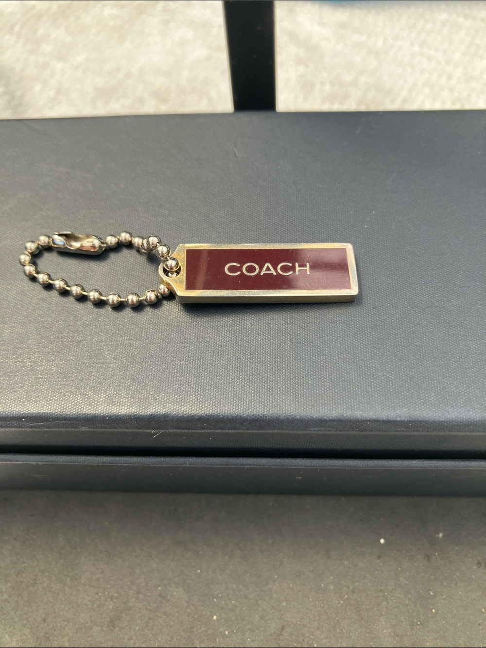 Coach small 1” gold and Burgandy bag charm hang tag